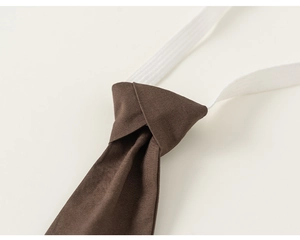 Detailed close-up of dark brown pre-tied necktie with elastic strap for boys' formal wear