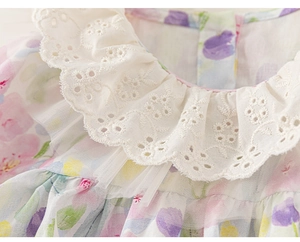 Detail of baby girl floral dress featuring elegant white lace embroidery collar design