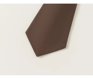 Detailed close-up showing the fine diagonal texture of a brown boy's gentleman necktie
