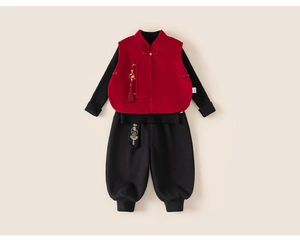 Detail of red quilted Chinese vest with traditional frog buttons and fringe tassels