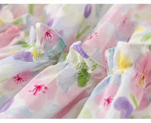 Detailed macro view of floral cotton fabric with ruffled edges and fine stitching craftsmanship