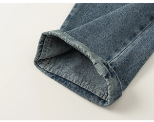 Close-up of vintage washed denim hem with neat double-stitch sewing and twill texture