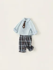 Three-piece boy gentleman outfit with blue shirt, brown tie, and plaid trousers