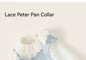 Detail of baby girl outfit showing white lace collar shirt and blue knit sweater vest