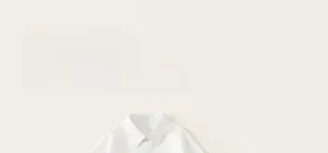 Detailed view of kids' minimalist white collared shirt fabric and clean casual design