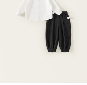 Flat lay of boys white button-up shirt and black cargo joggers with elastic cuffs