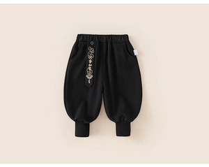 Detail of children's black winter pants with Chinese embroidery and elastic waistband
