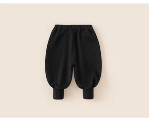 Detail of black children's joggers featuring elastic waistband and ribbed ankle cuffs