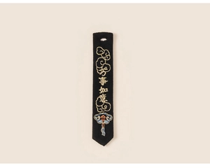 Detail of traditional Chinese embroidery with gold characters and clouds on black fabric