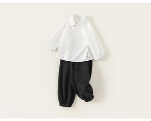 Flat lay of boys' white long-sleeve shirt and black cargo pants set for children