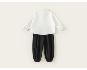 Detail view of boys white cotton shirt and black cargo pants with elastic cuffs