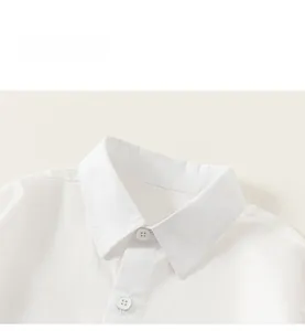 Detail shot of a white long-sleeve cotton shirt featuring a classic collar and white buttons