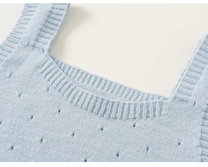 Detailed close-up of light blue knitted hollow vest with fine ribbed square neckline