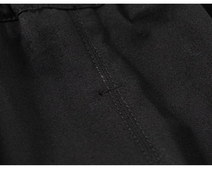 Close-up of black twill fabric with reinforced double-row stitching on kids' pants