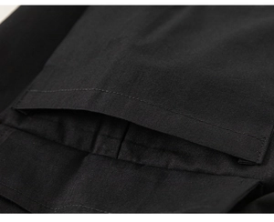 Close-up of high-quality black fabric texture and precise stitching on boys' pants pocket