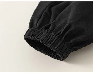 Detail view of the black elastic ribbed cuff on high-quality boy shirt and pants set