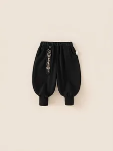 Kids black kung fu style joggers with embroidered festive belt and ribbed cuffs