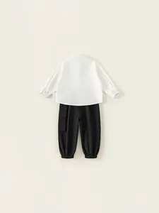 Boys casual outfit featuring white long sleeve shirt and black cargo joggers