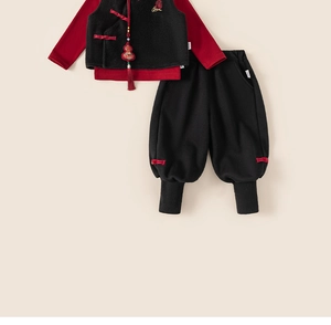 Detailed view of children's New Year outfit with red top, black vest, and cloud embroidery