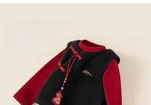 Detail of Chinese style kids vest with traditional knot buttons and embroidery