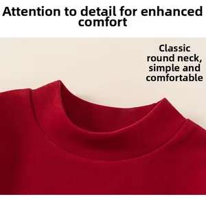 Detailed view of classic red crew neck stitching on comfortable cotton festive children's clothing