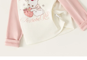 Close-up of pink raglan sleeve and cute cartoon rabbit print on cotton girl's t-shirt