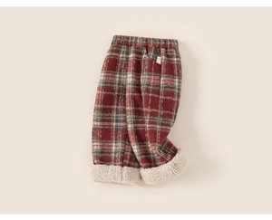 Detail of red and brown plaid children's pants with thick cream lamb wool lining
