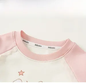 Detail of pink ribbed round neck with lace raglan sleeves and star print patterns