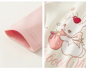 Detail of pink ribbed cuffs and cute cartoon rabbit print on cotton long sleeve T-shirt