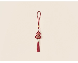 Close-up of red festive gourd pendant with Jixiang embroidery and silk tassels