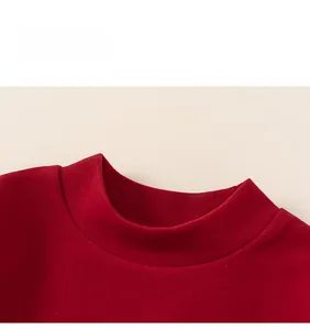 Detail shot of the ribbed round neckline on this red festive kids sweatshirt