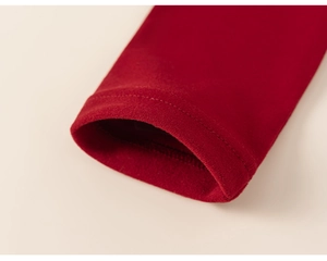 Detail of red knit sleeve cuff showing premium stitching and soft texture for kids clothing