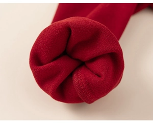 Detailed close-up of warm fleece lining and knit texture on the red cuff of kids' clothing