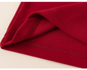 Close-up of fine double-needle stitching and knit texture on red children's lunar new year vest