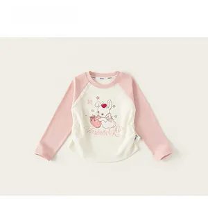 Detail of a girls long sleeve raglan tee with cute cartoon rabbit and strawberry graphic