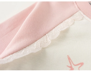 Close-up of girls cotton T-shirt with pink raglan sleeves and delicate lace detailing
