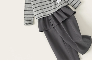 Detail of grey striped hoodie with ruffled waist pants and buttons on soft knit fabric