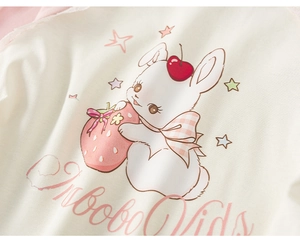 Close-up of the soft cotton fabric featuring a cute cartoon rabbit and strawberry print