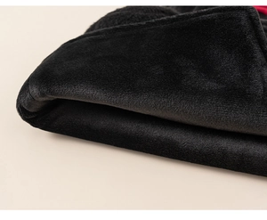 Close-up detail of premium thick black plush fabric texture with soft warming fibers