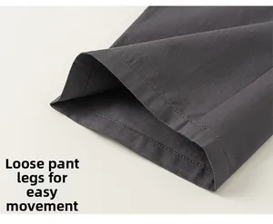 Detailed macro view of loose-fitting dark grey trouser cuffs with fine stitching