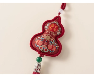 Detail of red gourd pendant with Ping'an Xile embroidery and silk tassel fringe