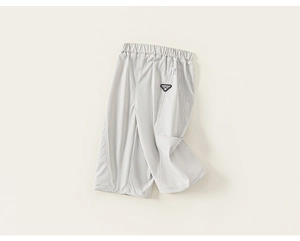 Detail of light grey kids sports shorts showing elastic waistband and brand patch