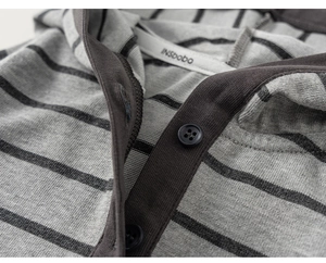 Close-up of gray striped knitted hoodie with buttons and high-quality fabric texture