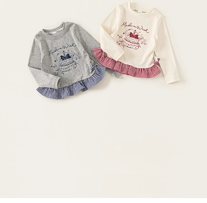 Close-up of girls' cotton long sleeve top with cake print and plaid ruffle hem detail