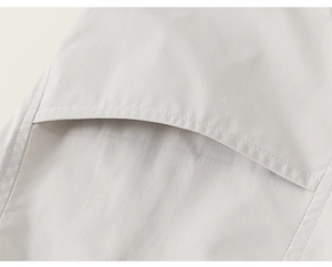 Close-up of minimalist solid color cotton fabric texture and pocket stitching detail