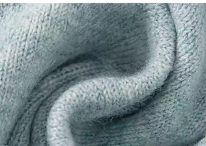 Macro detail van zachte blauwe gebreide stoftextuur toont premium wolvezelkwaliteit