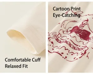 Detail of ribbed cuffs and red cartoon cake print on cream cotton long sleeve shirt
