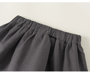 Detail view of the elastic waist on dark grey straight pants with durable stitching