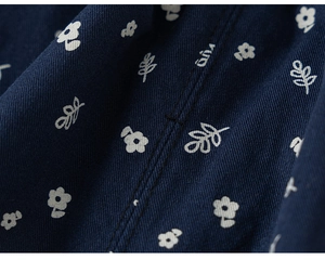 Close-up of navy blue floral fabric with detailed twill texture and neat stitching