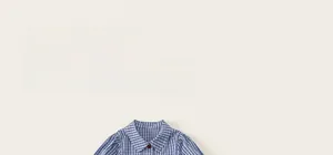 Detail of blue and white checkered girl's blouse with a red button on the collar